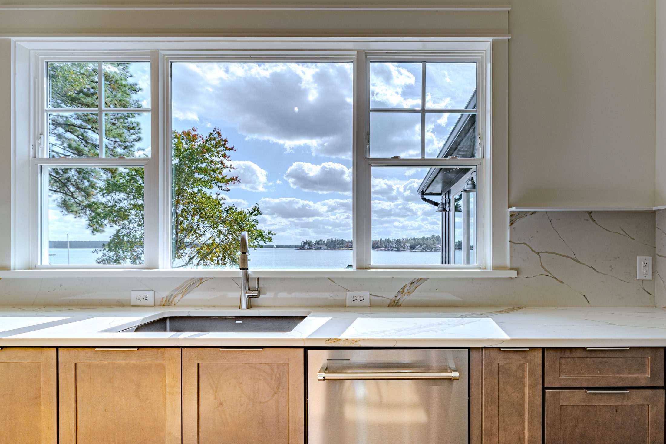 Kitchen sink beneath a window with lake views