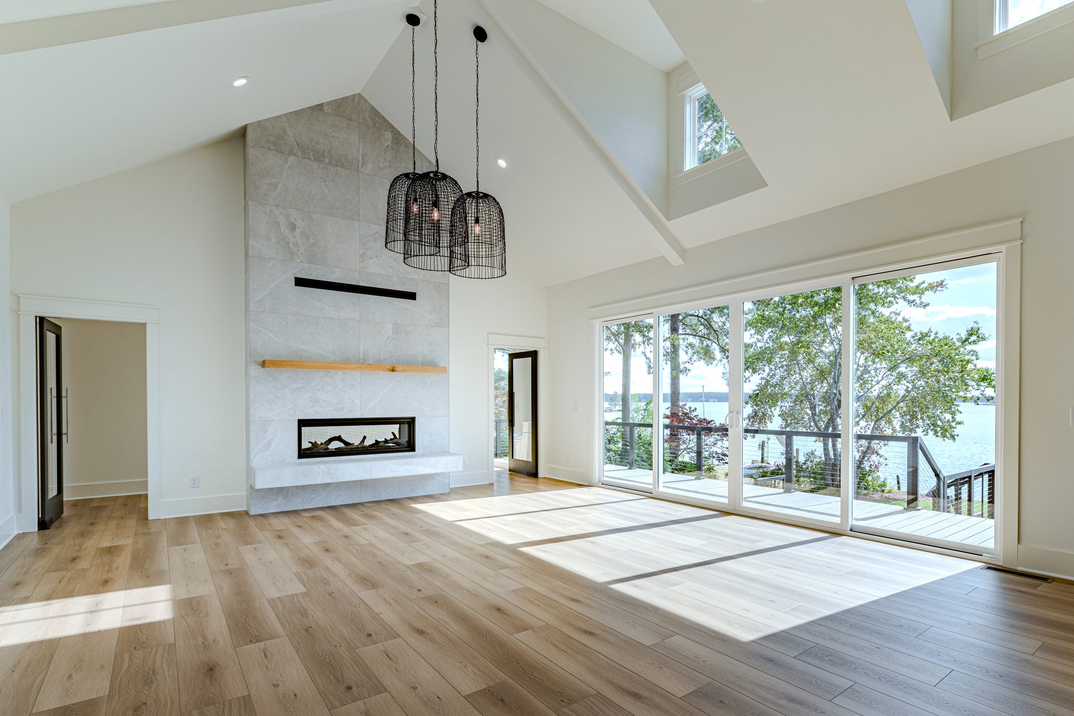Great room with fireplace and lake-facing windows