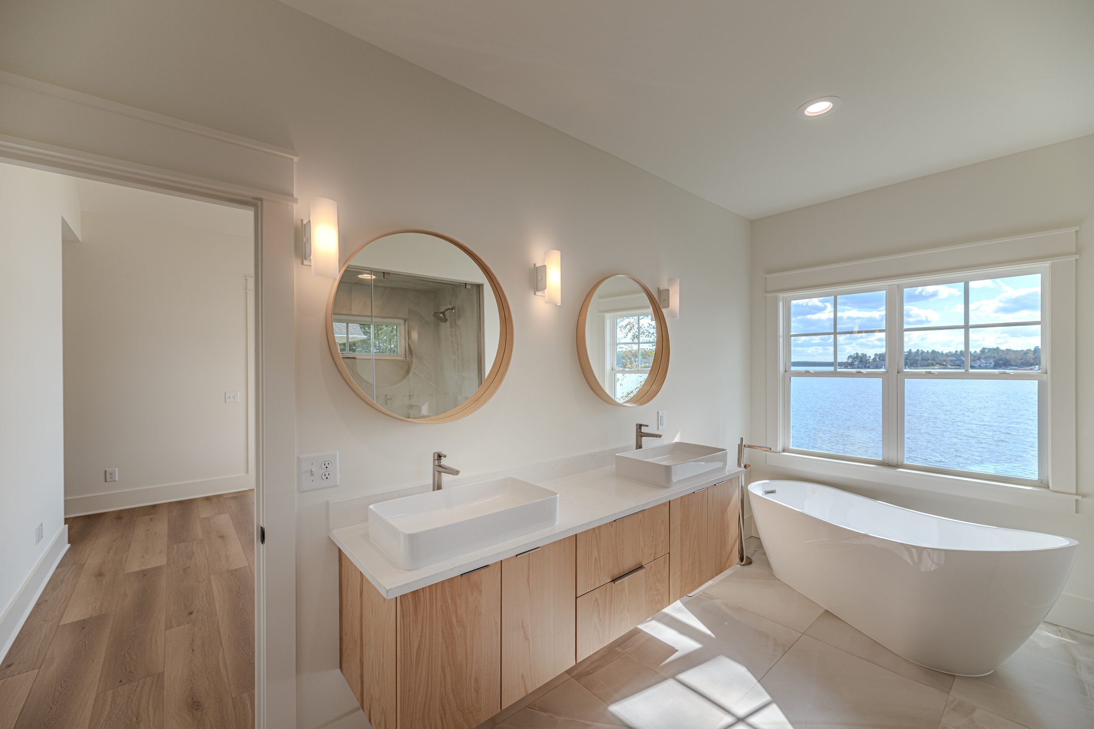 Primary bathroom with double vanity and freestanding tub