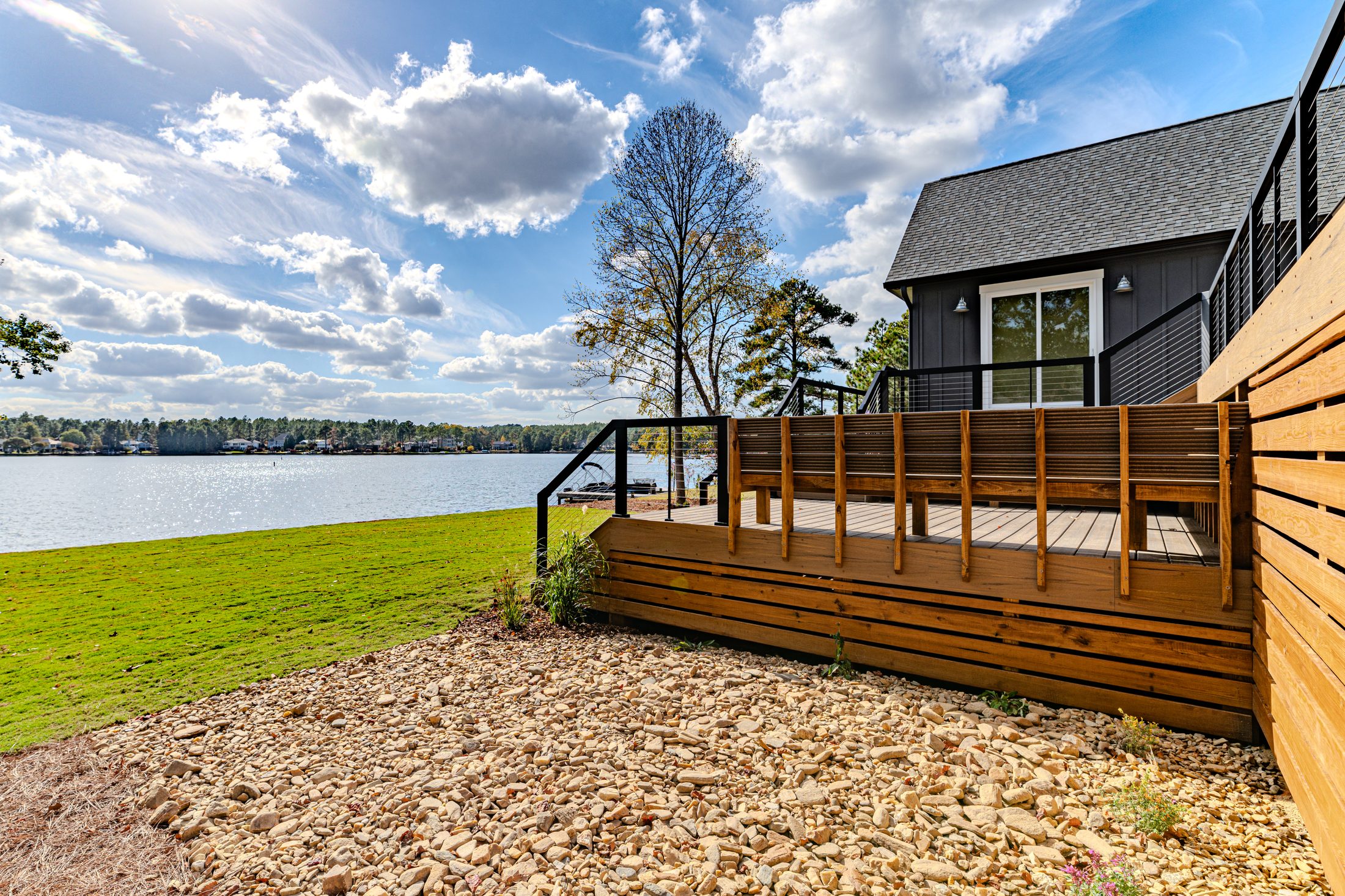 Rear exterior and lakefront setting of a Lake Auman custom home