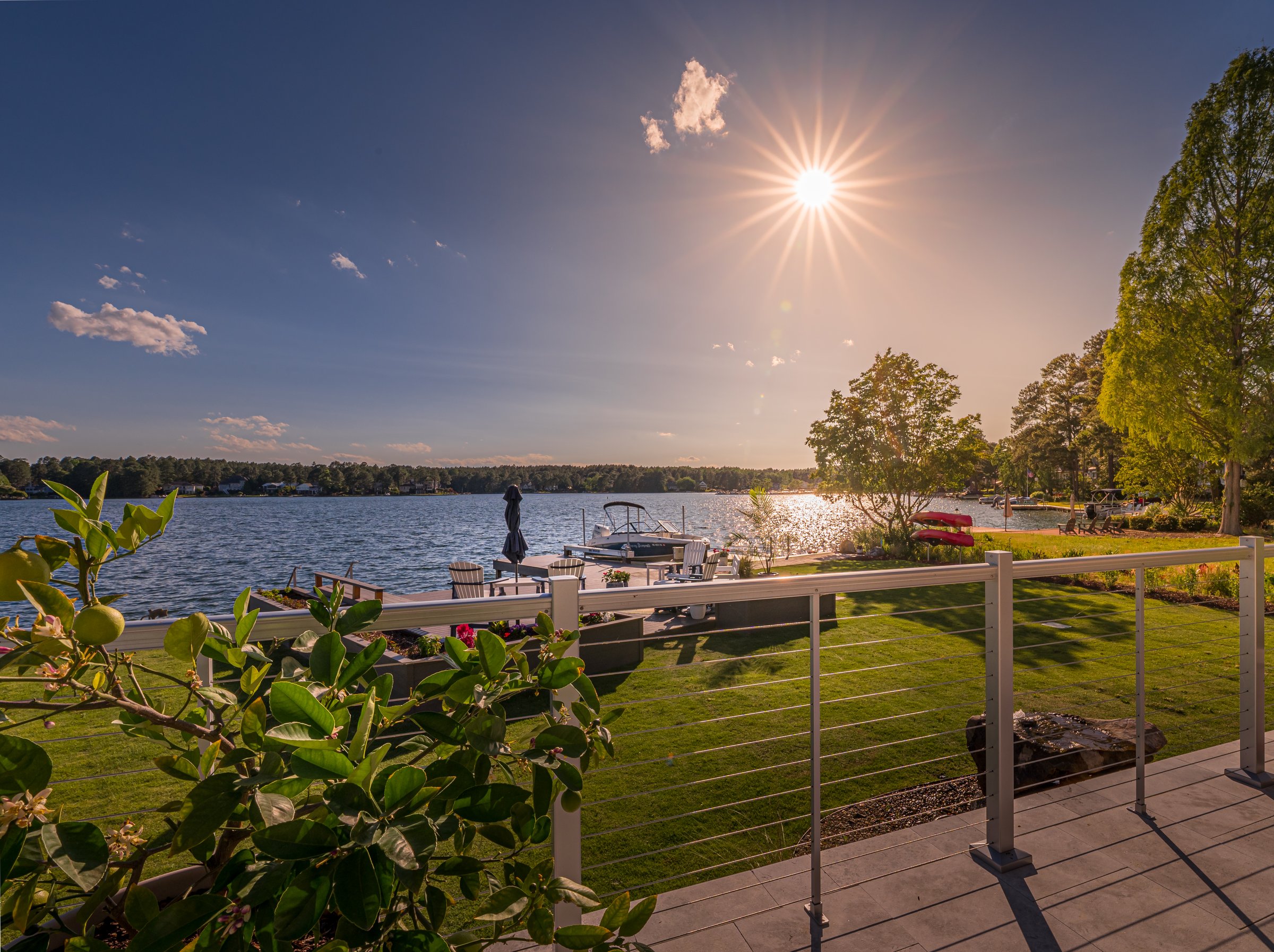 Outdoor living custom home on Lake Auman in Seven Lakes NC — evening waterfront
