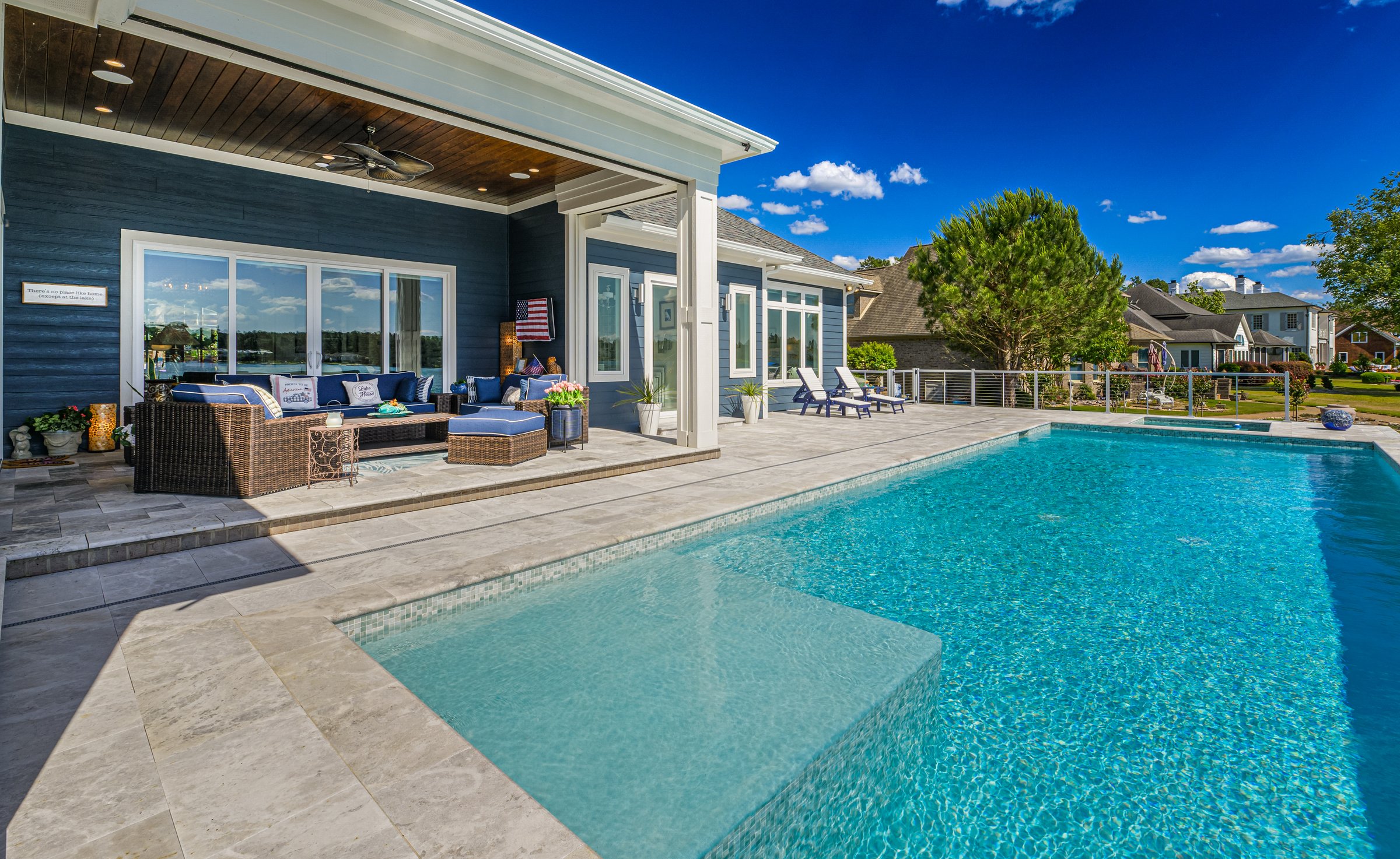 Outdoor living custom home on Lake Auman in Seven Lakes NC — pool and covered porch