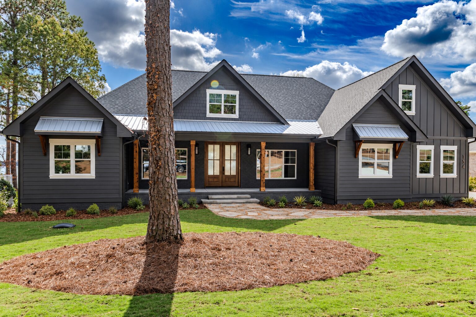Classic custom home on Lake Auman in Seven Lakes NC with dark exterior and timber porch