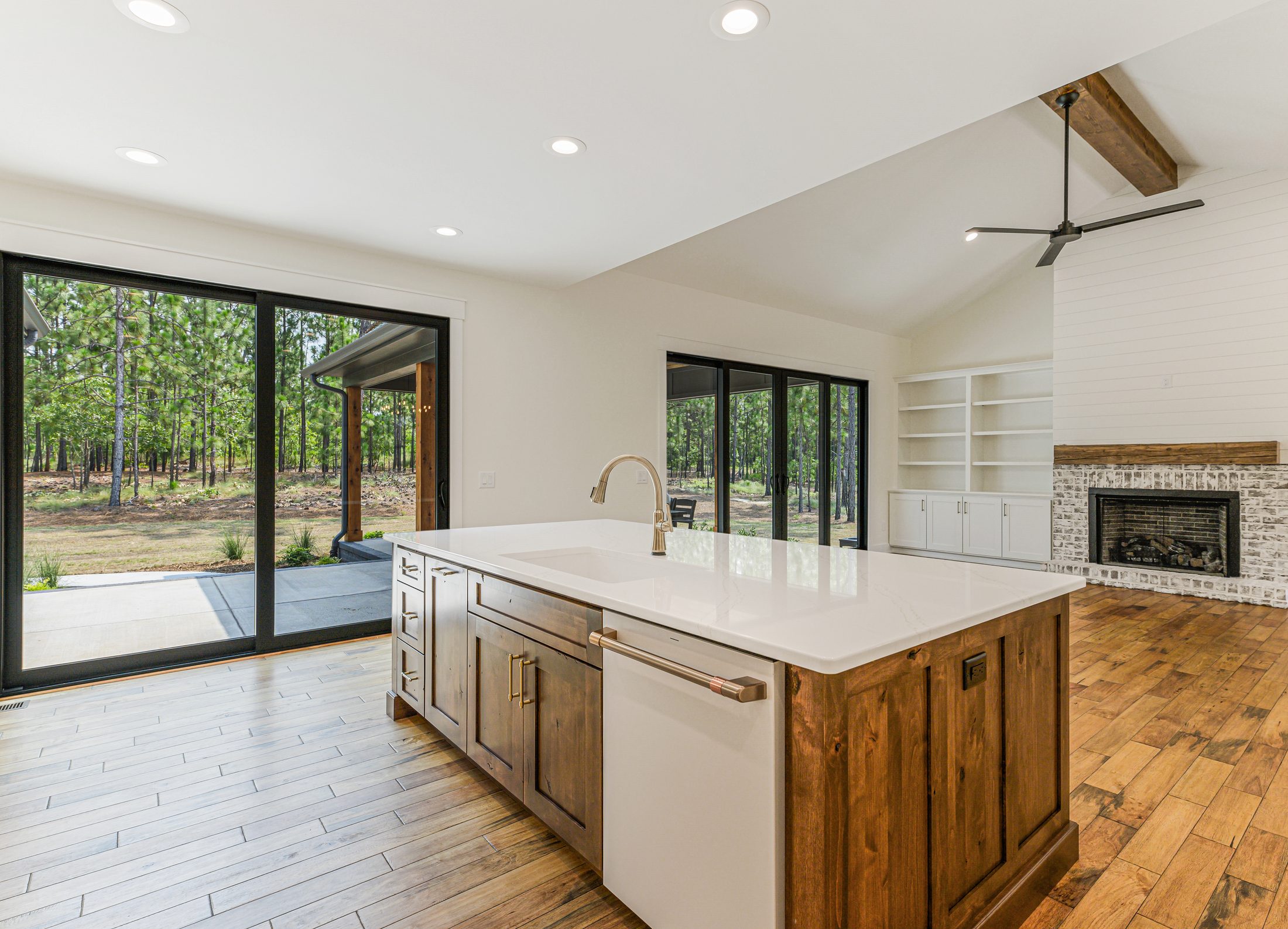 Open kitchen and great room with large glass doors to outdoor living