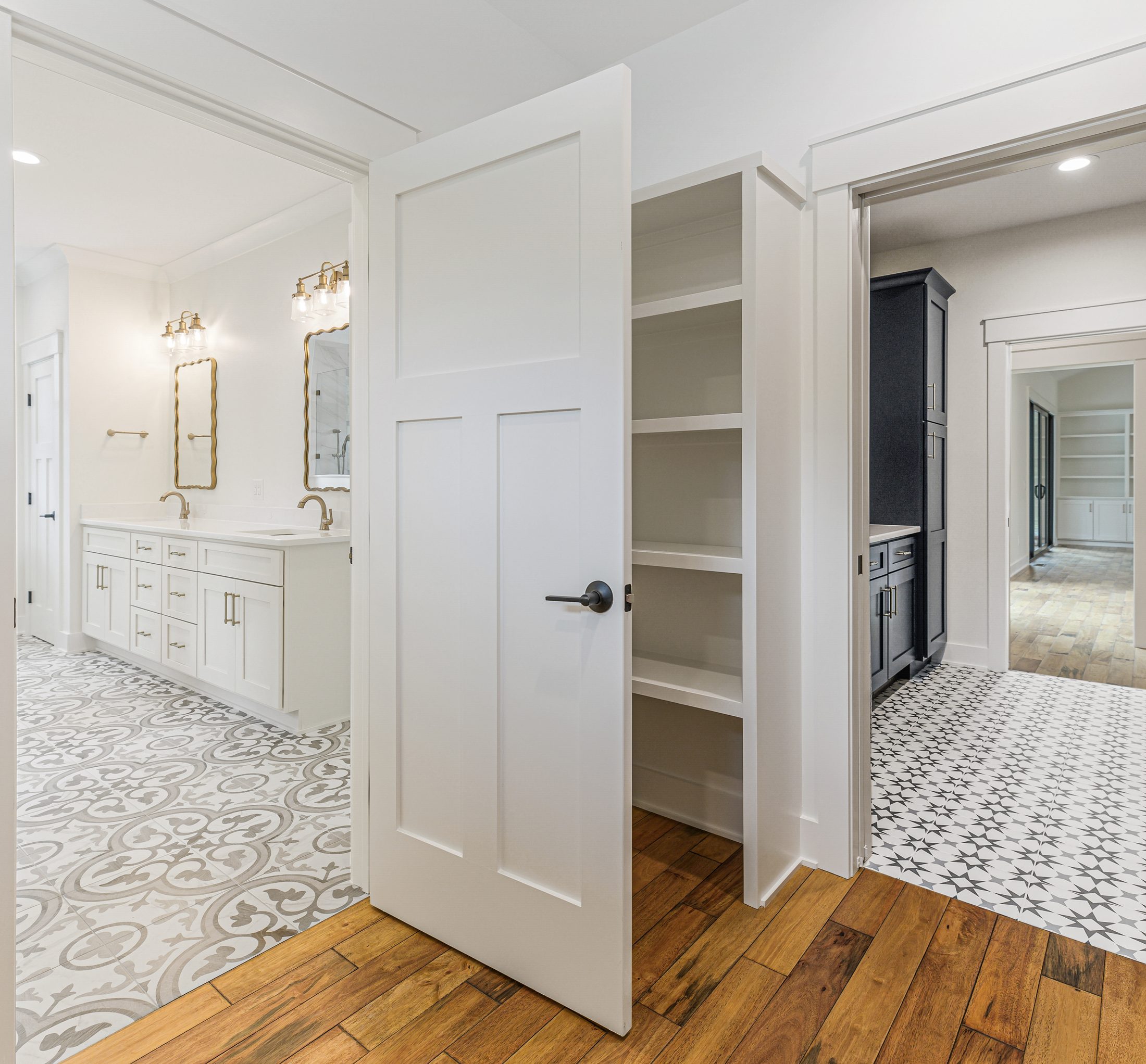 Primary bath and walk-in closet transition in a Arbor Creek custom home in West End